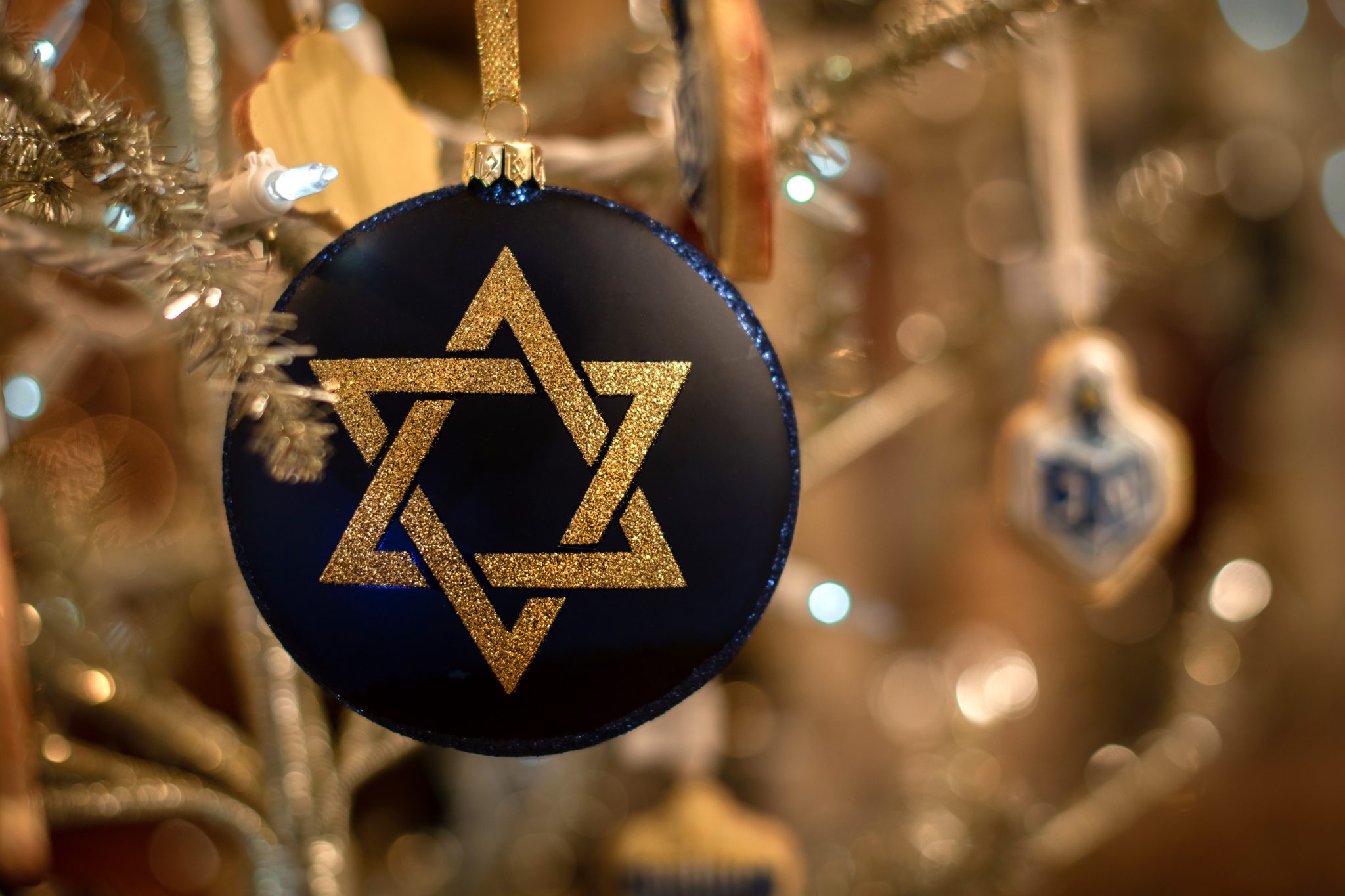 a Star of David ornament on a Christmas tree
