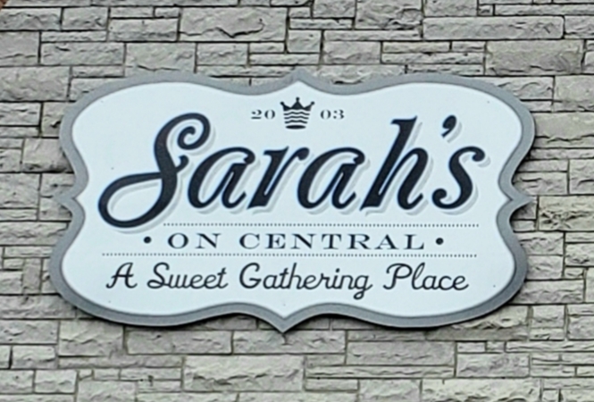 Stone wall with a sign for Sarah's on Central Bakery in Eureka