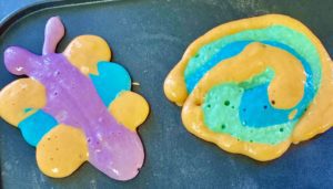 Brightly colored butterfly and spiral shaped multicolor pancakes