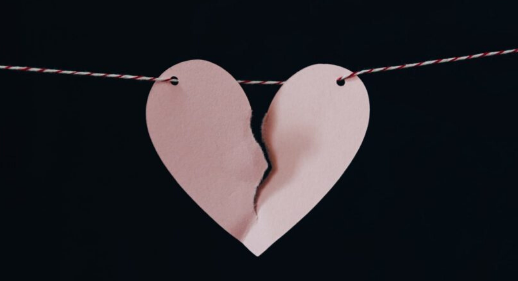 a torn paper heart held together on a string to symbolize race and racial discrimination