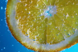 a close up of a lemon wedge in sparkling water