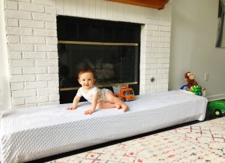 DIY hearth seat cover with a baby sitting on top of it