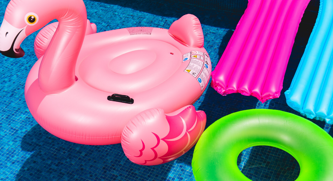 pool floats and an inflatable flamingo in a swimming pool