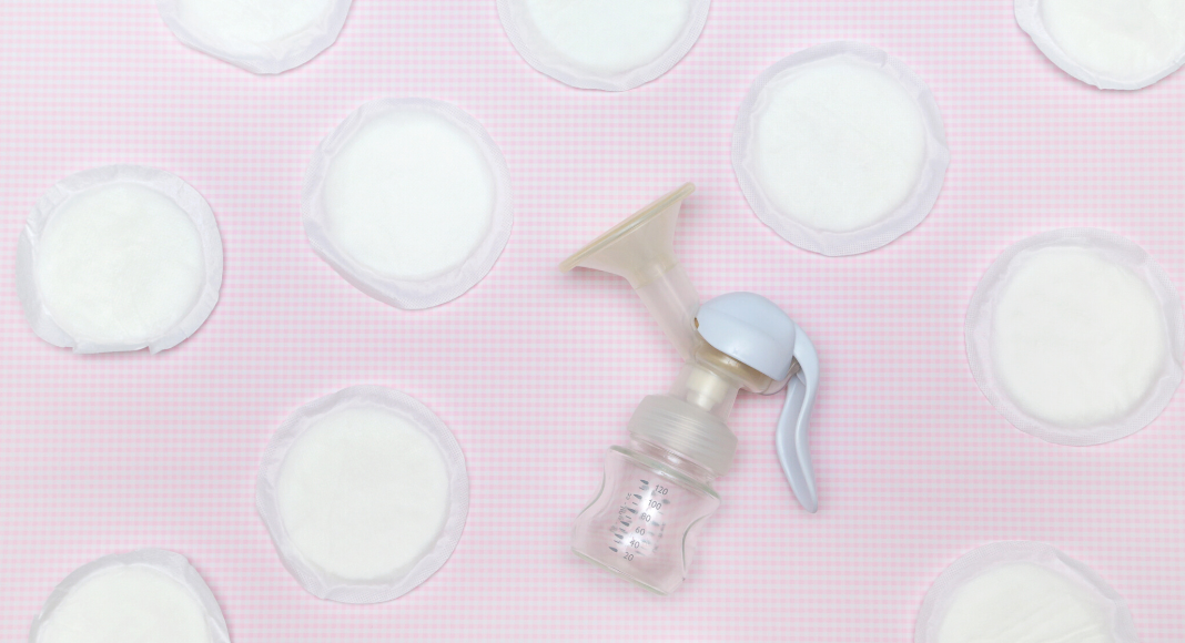 a breast pump and breast pads set against a pink background