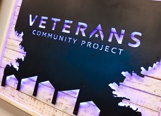 a sign with the words Veterans Community Project
