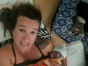 a mom holding her newborn son after a natural home birth
