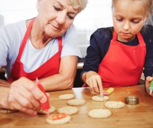 grandma baking cookies with her granddaughter