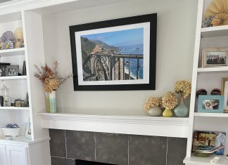 a fireplace with painted gray tile and white grout