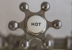 a close up of hot water handle in the shower