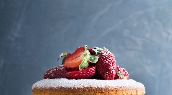 British Victoria sponge cake with berries on a cake pedestal