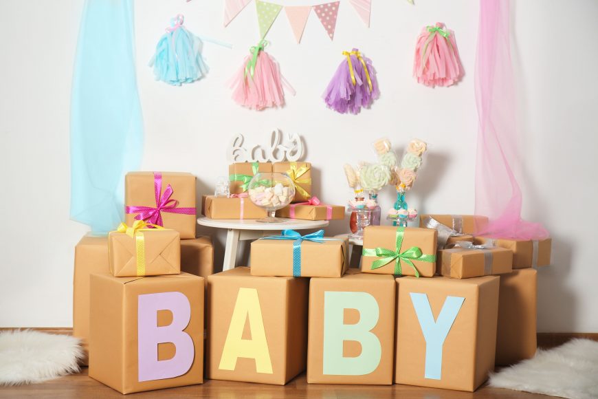 baby gifts on a table with baby shower decorations
