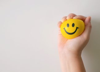 a yellow stress ball with a smiley face