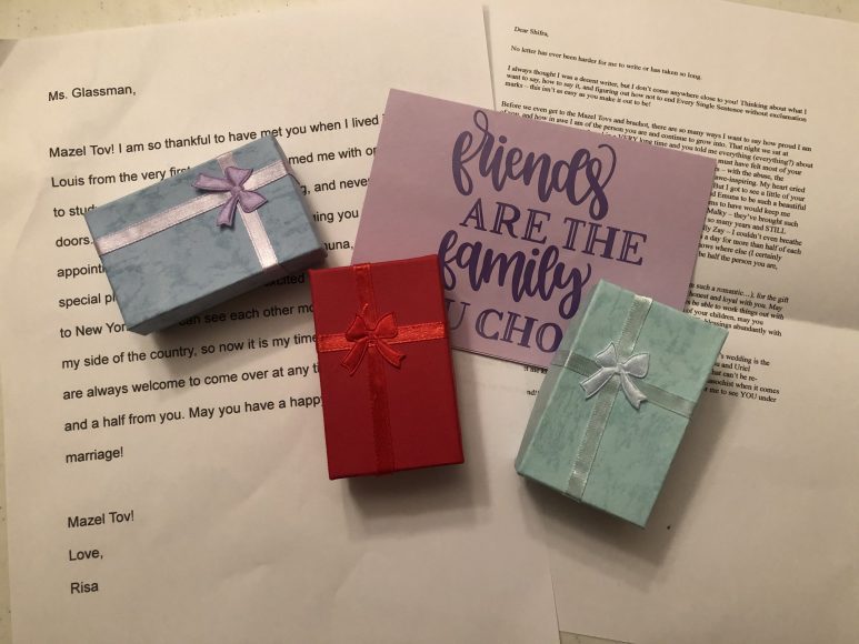 different colored gift boxes on top of typed letters of appreciation, with the quote, "Friends are the family we choose"