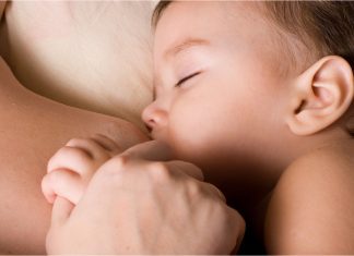 a baby boy breastfeeding on his mom's chest
