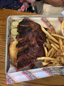 A silver tray with barbecue ribs and fries from Burnt Ends in Overland Park