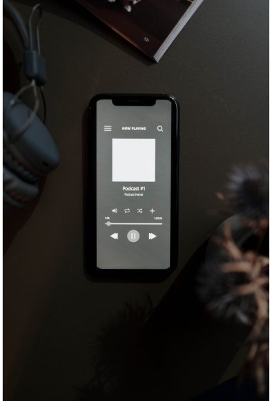 a cell phone with an image of a podcast cued up