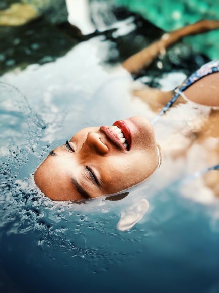a woman floating in water with her face exposed