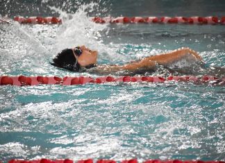a girl swimming in a race