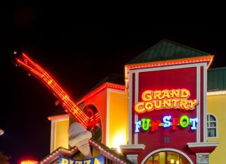 a picture of The Grand Country Fun Spot in Branson, Missouri all lit up at night