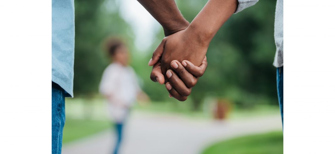 a close up of a couple holding hands