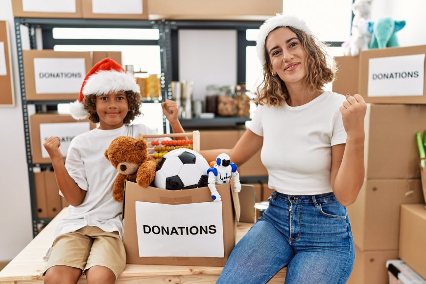 a mom and her child volunteering with donations for the holidays