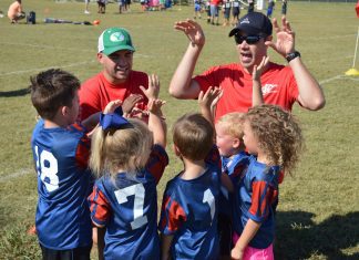 a coach talking to his players at a youth soccer game