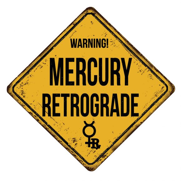 a yellow caution sign with the words, “Warning! Mercury Retrograde"