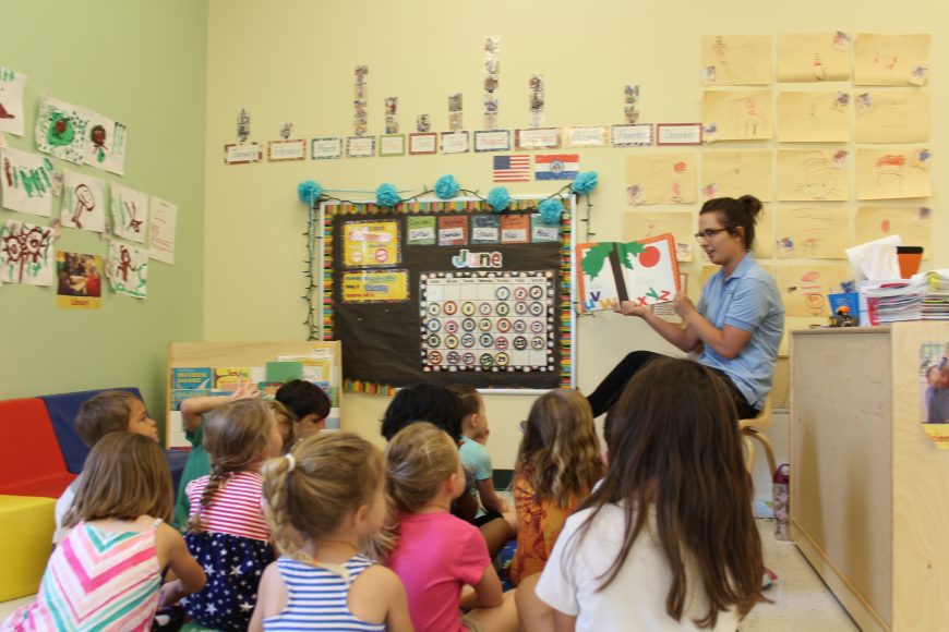 kindergarten kids reading together in a Kiddie Academy classroom