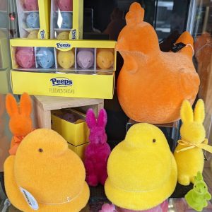 stuffed chickens, bunnies, and peeps next to real candy peeps for Easter