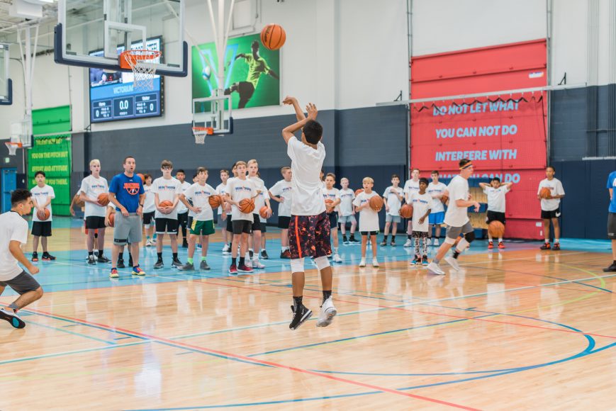 Kids playing basketball at a Breakthrough Basketball youth summer camp