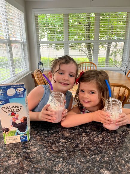 two girls drinking fruit smoothies made from Organic Valley milk