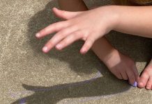 a summer science activity as a child looks at the shadow of their hand