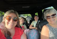 a mom and grandma in the front seat, road tripping with their two tween girls in the backseat