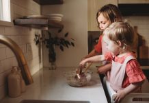 baking with toddlers as two toddlers work at the kitchen counter