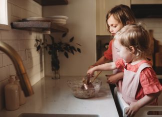 baking with toddlers as two toddlers work at the kitchen counter
