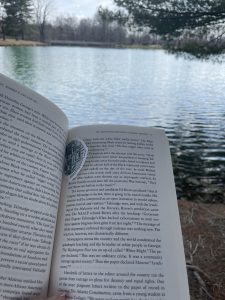 Taking a break to relax and read a book at a local park.