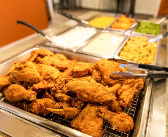 a buffet with fried chicken and sides 