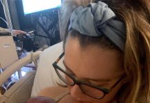 a mom holding her newborn baby after using a doula to assist with the birth