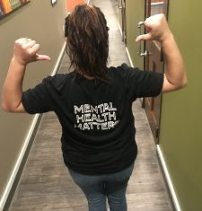 a woman wearing a “mental health matters” t-shirt