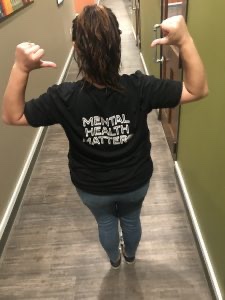 a woman wearing a “mental health matters” t-shirt