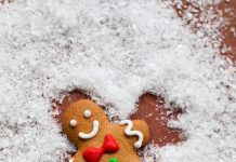 a gingerbread man making a snow angel in sugar