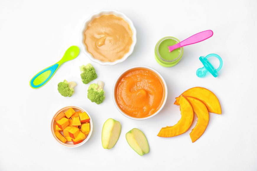 bowls of pureed baby food with toddler spoons 