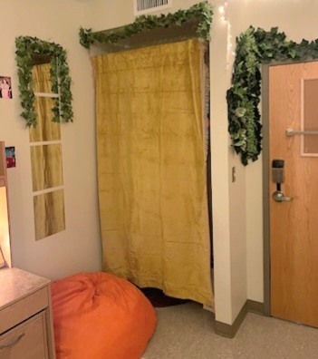a yellow curtain covering a dorm closet 