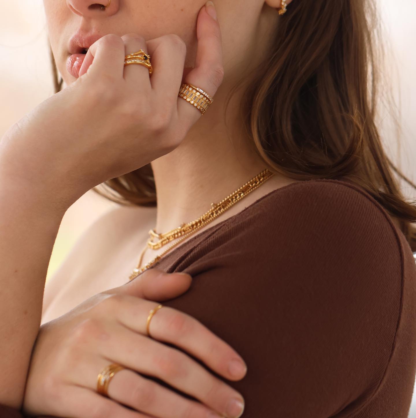 a model wearing Ptera Jewelry rings and necklaces